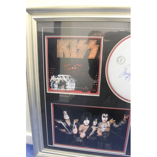 597 - Framed memorabilia display of Kiss with drum skin signed by Eric Singer surrounded by four pictures ... 