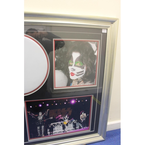 597 - Framed memorabilia display of Kiss with drum skin signed by Eric Singer surrounded by four pictures ... 