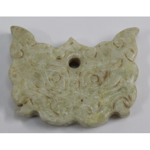 181 - Three Chinese archaic and archaised jade carvings to include a belt hook with dragon head carving, a... 