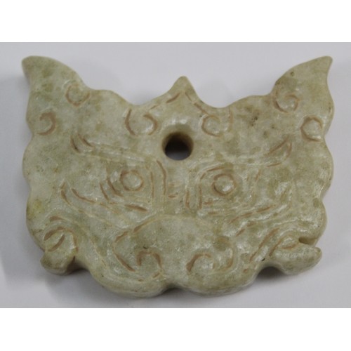 181 - Three Chinese archaic and archaised jade carvings to include a belt hook with dragon head carving, a... 