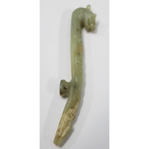 181 - Three Chinese archaic and archaised jade carvings to include a belt hook with dragon head carving, a... 