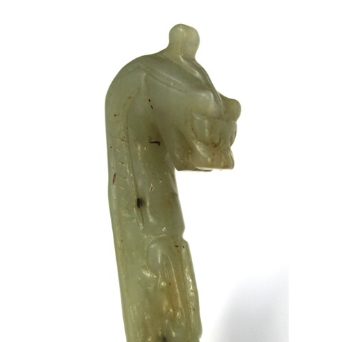 181 - Three Chinese archaic and archaised jade carvings to include a belt hook with dragon head carving, a... 