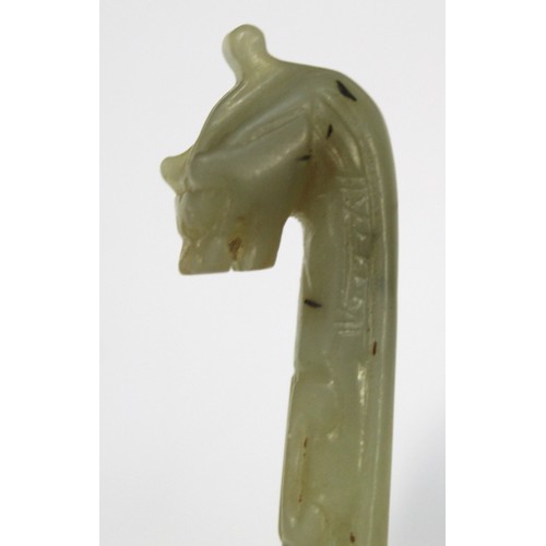 181 - Three Chinese archaic and archaised jade carvings to include a belt hook with dragon head carving, a... 