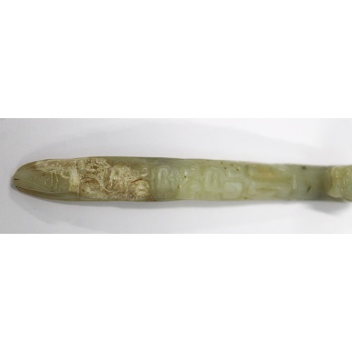 181 - Three Chinese archaic and archaised jade carvings to include a belt hook with dragon head carving, a... 