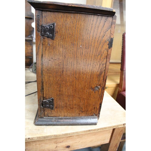 208 - Small Georgian oak hanging cupboard of rectangular form, the panelled door opening to reveal three s... 