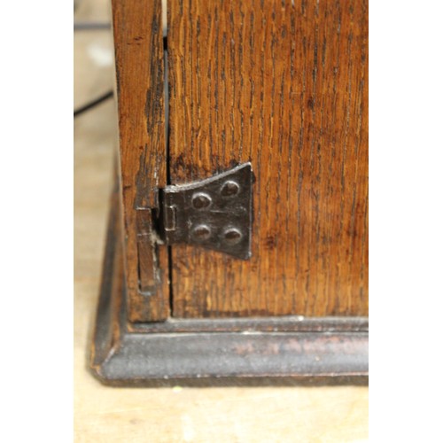 208 - Small Georgian oak hanging cupboard of rectangular form, the panelled door opening to reveal three s... 