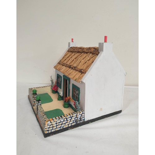 45 - Vintage wooden painted model cottage with white walls and rush roof. H26cm