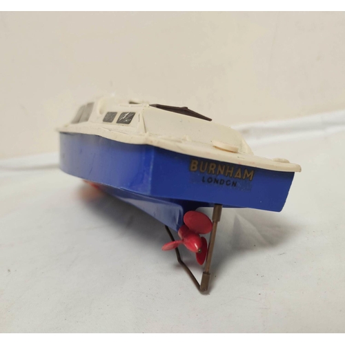 29 - Vintage 1950s clockwork and friction powered toys to include a Tri-ang Burnham model boat in plastic... 