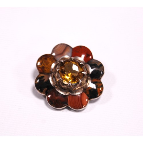 140A - Victorian pebble silver brooch modelled as a flowerhead with large citrine central stone surrounded ... 