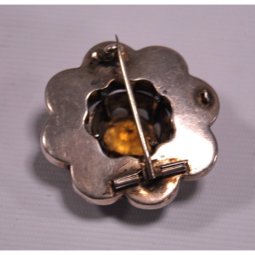 140A - Victorian pebble silver brooch modelled as a flowerhead with large citrine central stone surrounded ... 