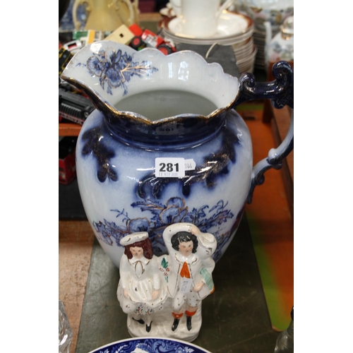 281 - Staffordshire flatback figure group and a Victorian blue and white jug.