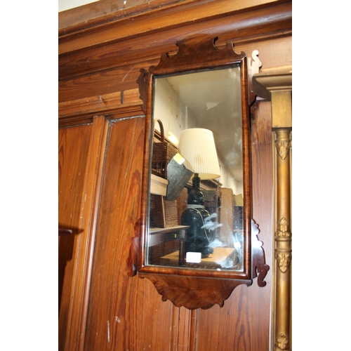 828 - Antique mahogany fret carved wall mirror, 74 x 36cm.