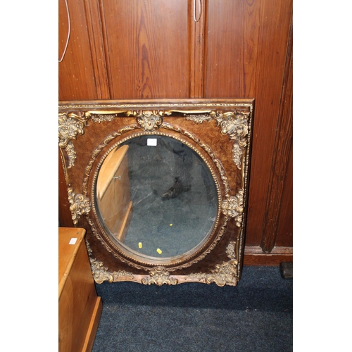 832 - Large elaborately decorated gilt framed oval wall mirror, 78 x 67cm.