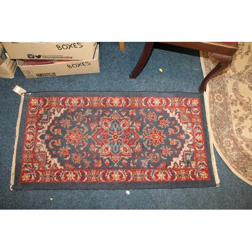 839 - Pair of blue ground, floral decorated rugs, 114cm x 57cm.