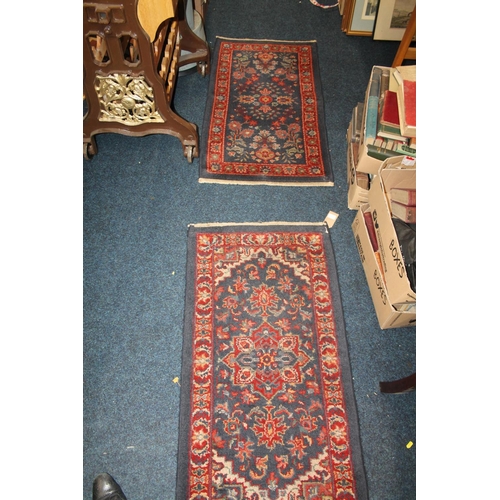 841 - Pair of modern black ground rugs, with geometric decoration, 88 x 68cm.