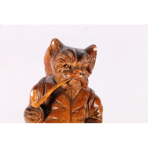 67 - Carved treen Black Forest style smoker's stand with dog smoking a pipe support, 18cm tall.