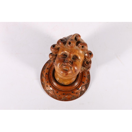 68 - Carved treen wall mask in the form of a cherub bust, 12cm tall.