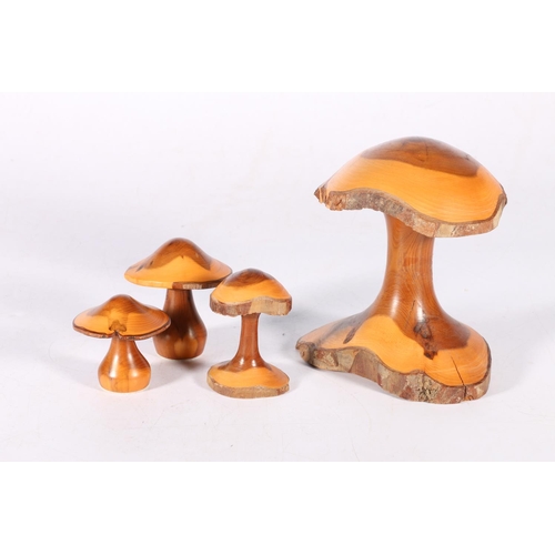 69 - Four turned treen mushrooms, the largest 14cm tall.