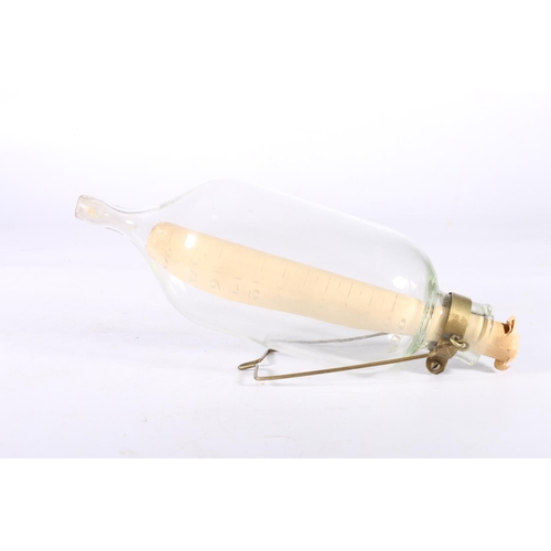 83 - Glass hanging flask measure, 35cm long.