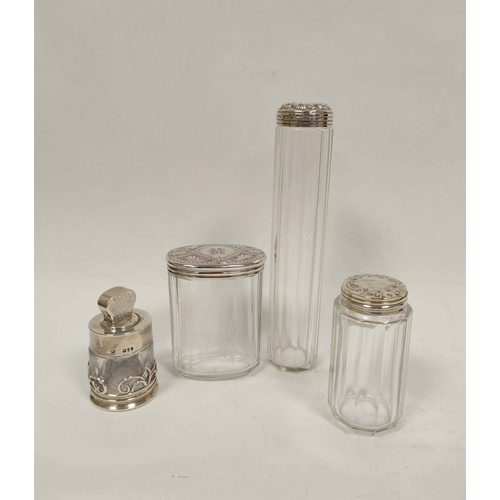 12 - Four silver mounted glass toilet bottles. 