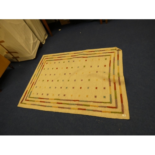 25 - Large modern cream rug.