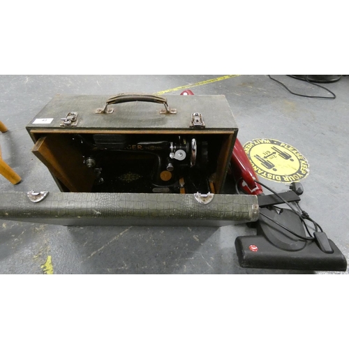 43 - Cased Singer sewing machine and lightweight vacuum cleaner.