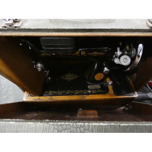 43 - Cased Singer sewing machine and lightweight vacuum cleaner.