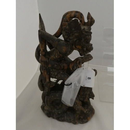 8 - Eastern carved hardwood figure of the Hindu monkey god Hanuman slaying a serpent, 28cm high.