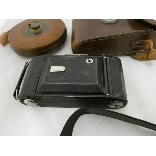 9 - Vintage camera and a tape measure.
