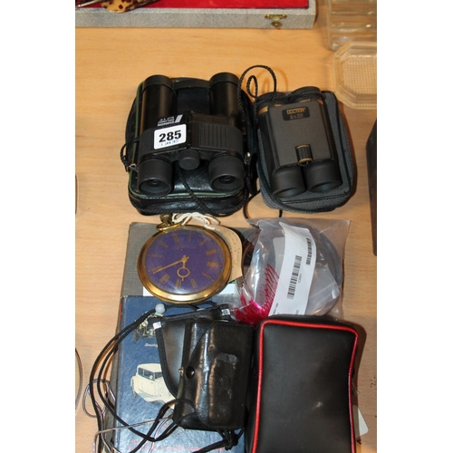 285 - Binoculars, a Swiss Goliath pocketwatch, a motor car pocket book, etc.