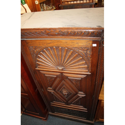 715 - Heavily carved oak single drawer wardrobe, with lion head to the cornice and carved central panel.