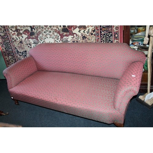 721 - Victorian mahogany upholstered three seater sofa on brass castors, signed Pratt.