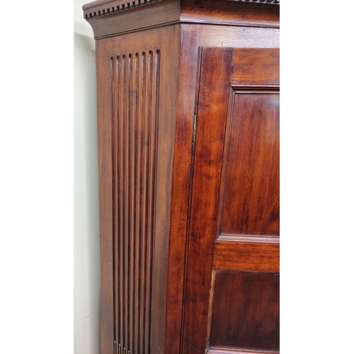 543 - 19th century mahogany corner cupboard with two panelled doors enclosing a shelved interior, on a fix... 