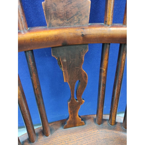 551 - 19th century ash and elm Windsor armchair, with a high hoop spindle back, above a curved solid seat,... 