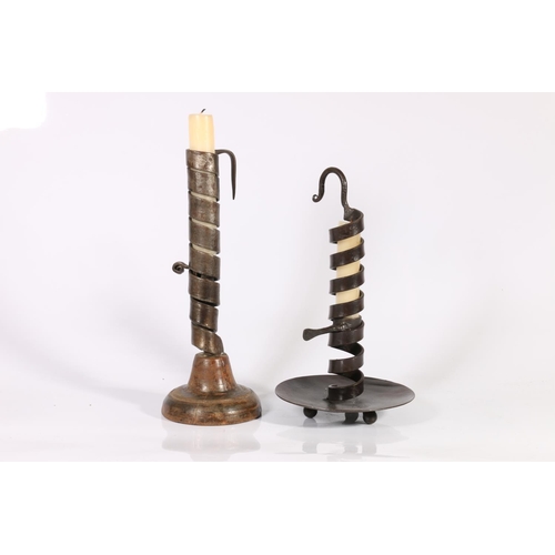 13 - Two medieval style wrought iron candlesticks, 24cm.