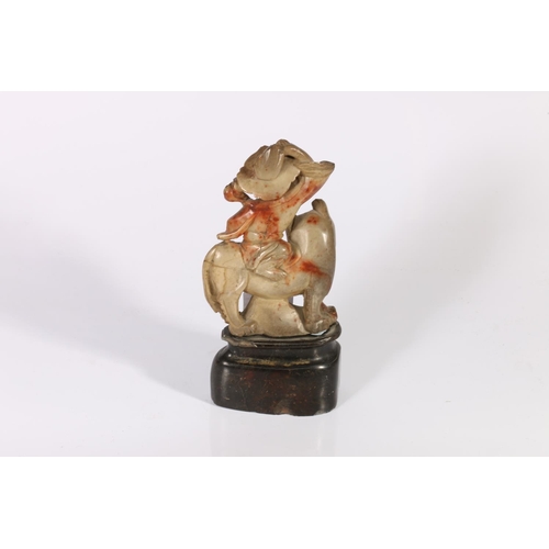 151 - Oriental carved soapstone figure on an animal.