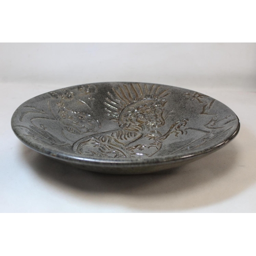 193 - Victorian studio pottery circular shallow bowl with sgraffito decoration depicting a mythical creatu... 