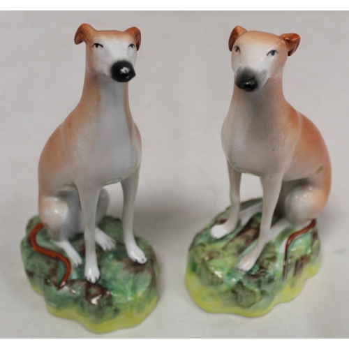 196 - Pair of Staffordshire Pottery greyhounds, each seated on naturalistic domed plinth base, each 21cm h... 