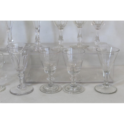 212 - Collection of fifteen antique drinking glasses including: a pair of flutes with faceted trumpet bowl... 