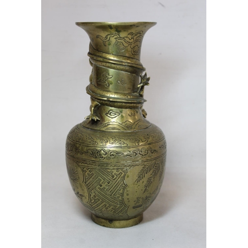 216 - Chinese brass vase of baluster form with incised panels of figures, precious things and moulded scro... 