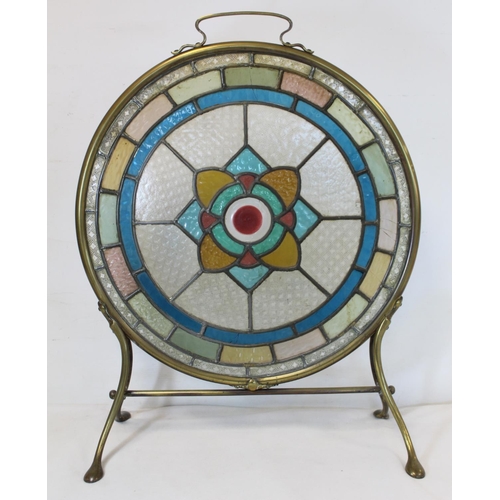 217 - Late 19th/early 20th century firescreen, the circular leaded stained glass panel with flowerhead mot... 