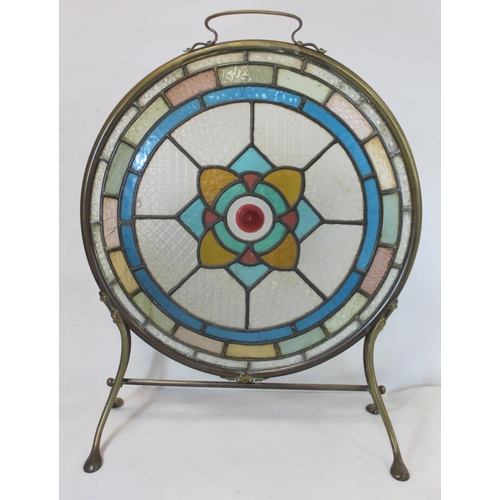 217 - Late 19th/early 20th century firescreen, the circular leaded stained glass panel with flowerhead mot... 