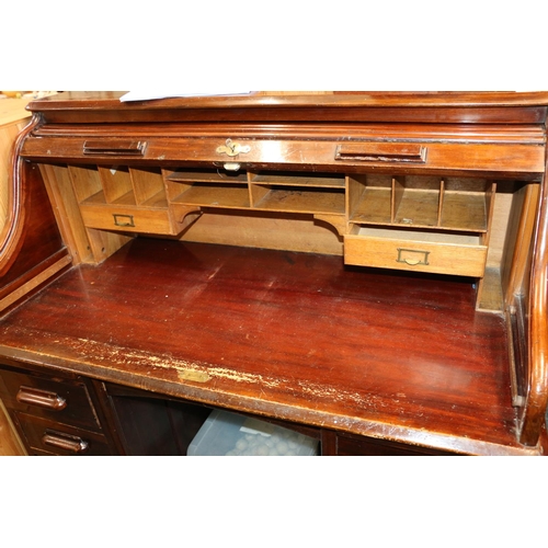 714 - Victorian mahogany roll top eight drawer knee-hole desk.