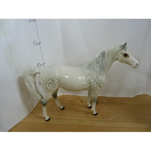 81 - Four Beswick dapple grey horses of various sizes including Arab Xayal, no. 1265.  (4)