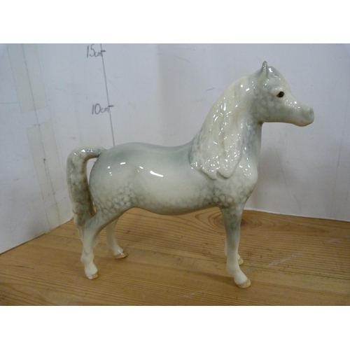 81 - Four Beswick dapple grey horses of various sizes including Arab Xayal, no. 1265.  (4)