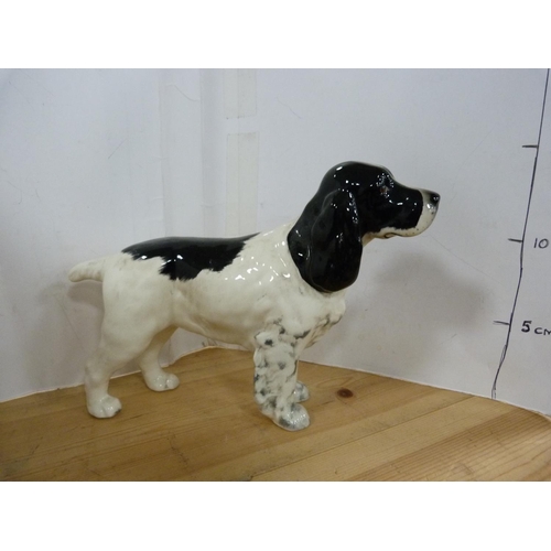 82 - Three Beswick figures of dogs including two Spaniels and another.  (3)