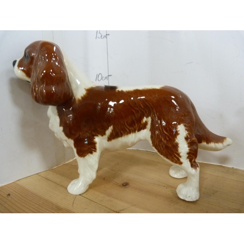 82 - Three Beswick figures of dogs including two Spaniels and another.  (3)