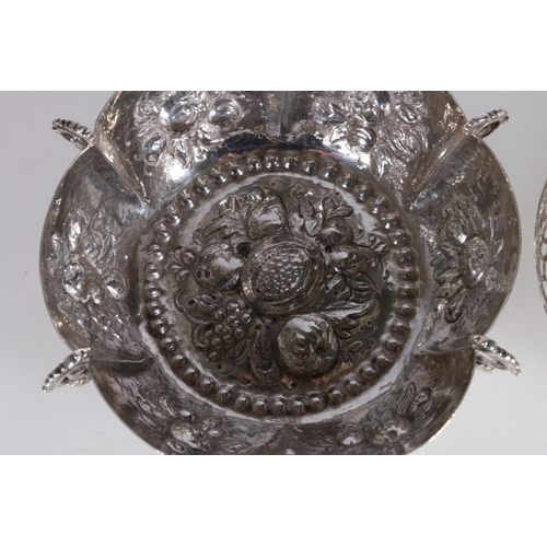 13 - Eastern white metal lobed dish with embossed fruit decoration, and a pair of pierced white metal bow... 