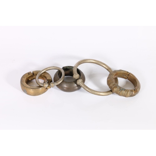 399 - Five heavy African bracelets, to include some with incised decoration, a bronze wide bracelet with g... 