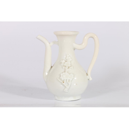 418 - Late 19th century blanc-de-chine small ewer with loop handle, the body decorated with applied cherry... 